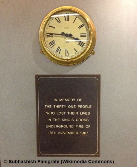 Memorial plaque with clock, King's Cross St. Pancras tube station, London